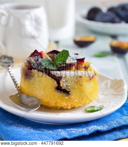 Homemade Plum Clafoutis Or Pudding On White Ceramic Plate. Rustic Homemade Plum Bakery Products Sele