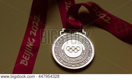 January 14, 2022, Beijing, China. Gold Medal Of The Xxiv Olympic Winter Games On A Yellow Background