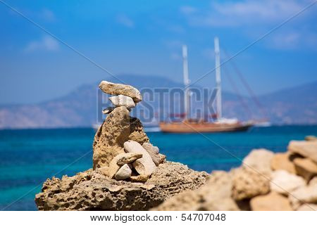 Stone figures on beach shore of Illetes beach in Formentera Mediterranean Balearic Islands
