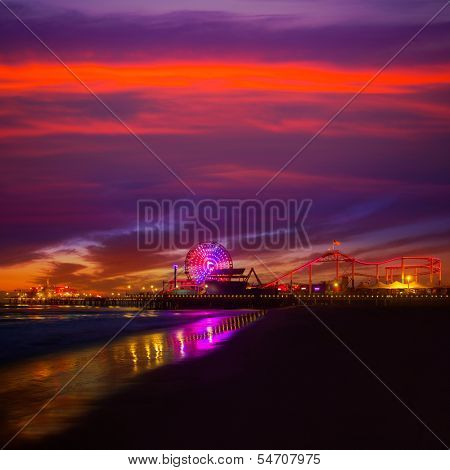 Santa Monica California sunset on Pier Ferris wheel and reflection on beach wet sand