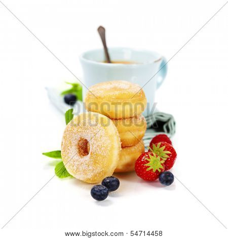 Coffee break with fresh berries and sugary donuts over white background