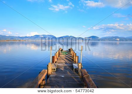 Wooden Pier Or Jetty And On A Blue Lake Sunset And Sky Reflection On Water. Versilia Tuscany, Italy