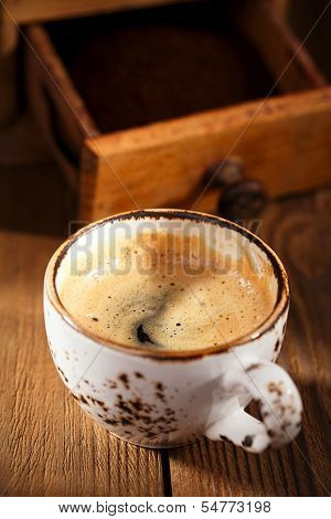 A cup of espresso coffee with Old coffee mill  textured tablem rustic style