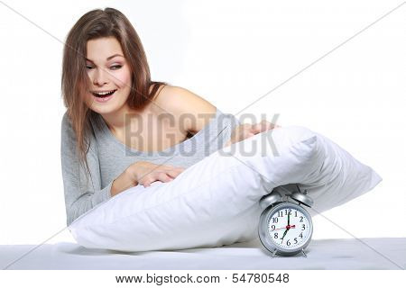 happy positive young  woman waking up and switching off the alarm clock