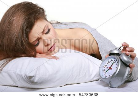 happy positive young  woman waking up and switching off the alarm clock