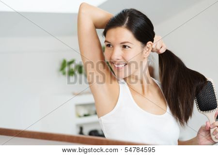 Smiling Woman Brushing Her Hair