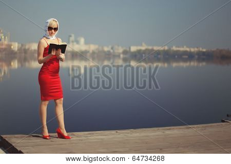 Girl In Red Dress Standing On The Shore