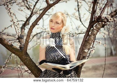 Beautiful Blonde Girl Standing Under A Tree