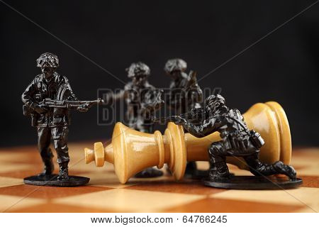 Toy soldiers kill chess King.