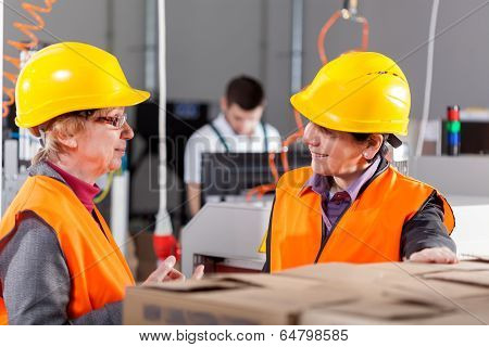 Employees Discussing At Production Area