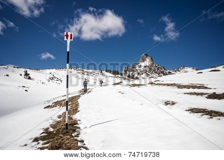 Tourists climbing the snowy mountain peak