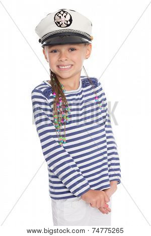 Playful little girl six years old in a suit cabin boy. Girl is six years old. On her cap emblem of Russia.