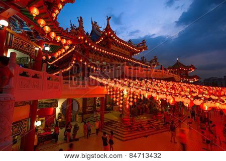 KUALA LUMPUR, MALAYSIA - FEBRUARY 23, 2015: Tourists visit the scenic Thean Hou Temple at night with hundreds of lanterns hung across the courtyard celebrating the lunar Chinese New Year.