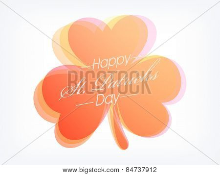 Creative shiny shamrock leaf with stylish text Happy St. Patrick's Day on grey background.
