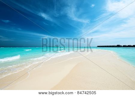Beautiful island beach with sandspit at Maldives