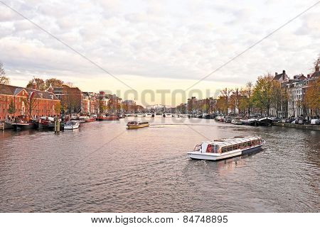City scenic from Amsterdam in the Netherlands at the river Amstel at twilight