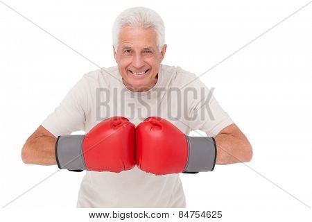 Senior man in boxing gloves on white background
