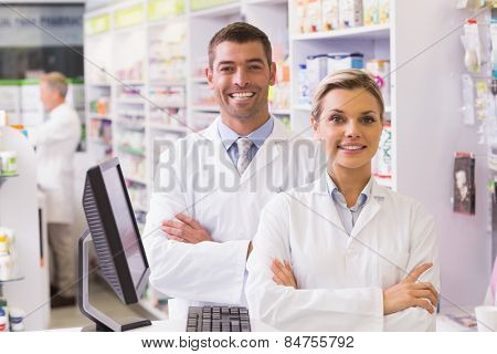 Team of pharmacists smiling at camera at the hospital pharmacy
