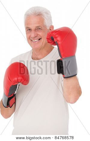 Senior man in boxing gloves on white background