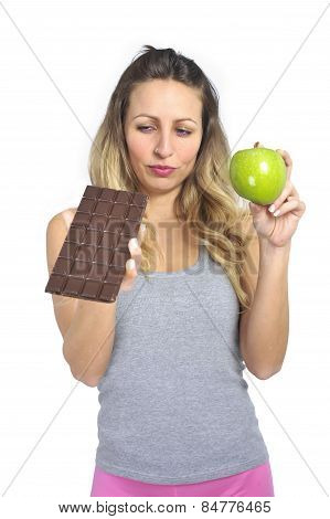 Attractive Woman Holding Apple And Chocolate Bar In Healthy Fruit Versus Sweet Junk Food Temptation