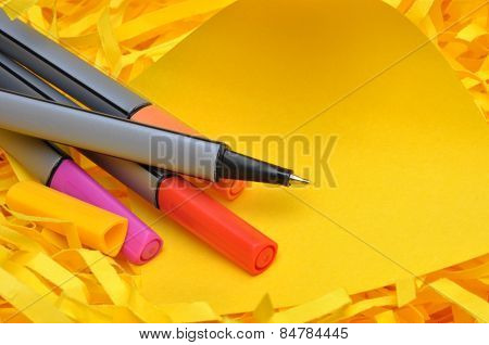 Markers with yellow sticky note