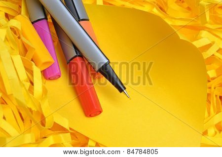 Markers with yellow sticky note