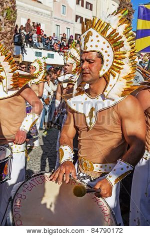 Sesimbra, Portugal. February 17, 2015: View of the Bateria, the musical section of the Samba School, playing for the dancers in the Brazilian Rio de Janeiro style Carnaval parade. With sound