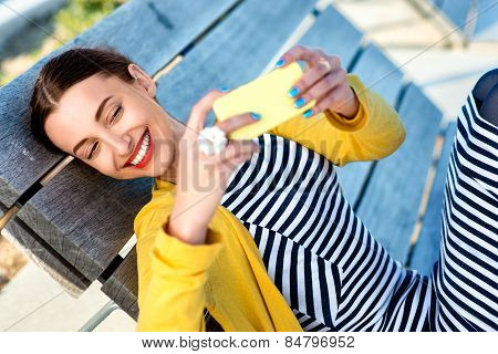 Woman with phone on sunbed