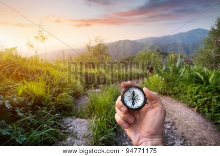 Hand With Compass In The Mountains