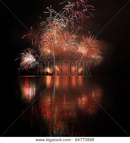 Colorful Fireworks With Reflection On Lake.