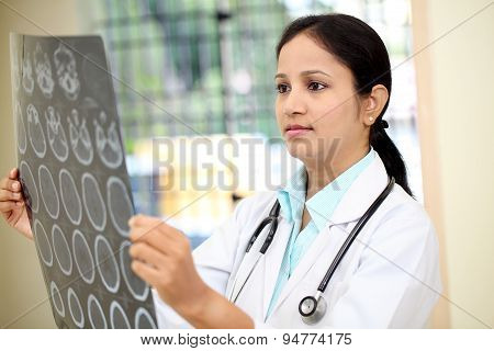 Female Doctor Examining A Brain Computerized Tomography Scan
