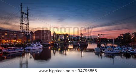 Train Bridge Over Harbor At Sunset