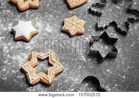 Delicious Christmas cookies with scattered powdered sugar on gray background