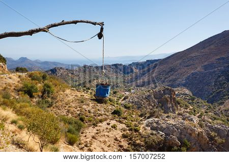 The bucket hanging over the precipice in the mountains of Crete