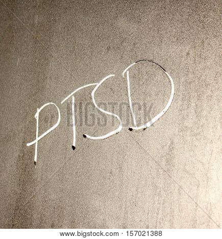 picture of a PTSD concept word on frosty window background