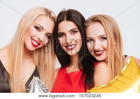 Closeup of three smiling gourgeous girls with bright makeup over white background