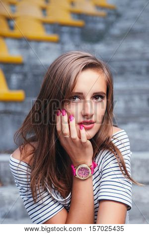 Fashionable Woman With Round Glasses Sitting On The Steps