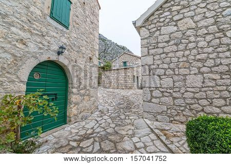 Small narrow street in Tucepi village in the slope of a mountain Biokovo.