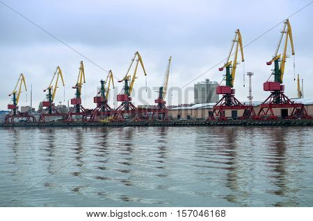 crane in the port red yellow green work