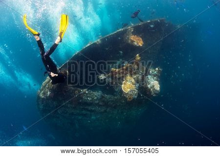 Free diver exploring the ship wreck in a tropical sea. Tulamben, Bali.
