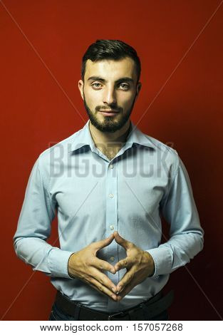 Attractive man with beard on red background