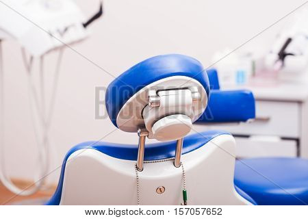 Professional blue dental chair with focus on headrest backside