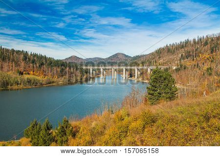 Colorful autumn landscape, bridge over Bajer Lake in Fuzine, Gorski kotar, Croatia
