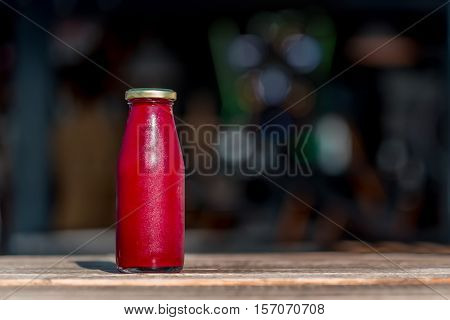 Organic cold-pressed raw pittaya juice in glass bottle