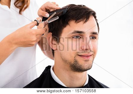 Happy Young Man Getting Haircut From Hairdresser