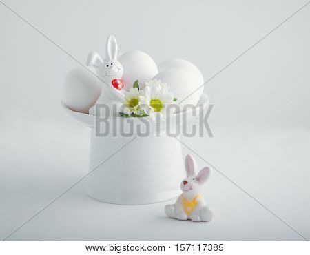 Easter symbols - Eggs and Bunny on a white table