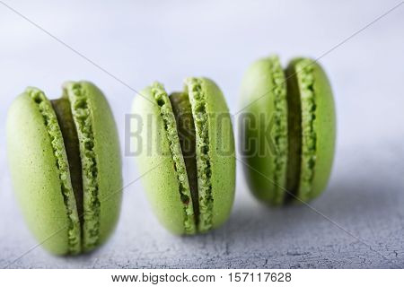 Three green french pistachios Macaroons on a table