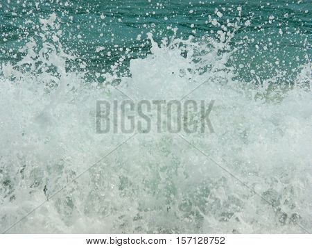 The waves are coming broken by coral