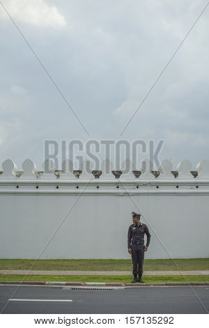 BANGKOK, THAILAND - OCT 15, 2016 : A police standing in front of The Grand Palace road.
