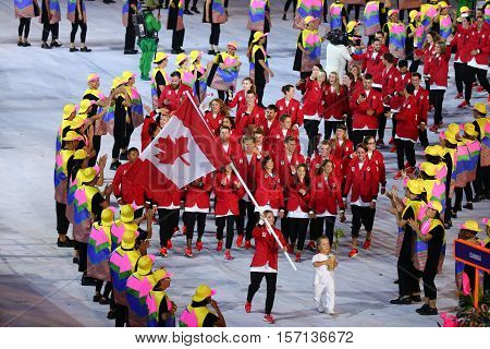 RIO DE JANEIRO, BRAZIL - AUGUST 5, 2016:Olympic champion trampoline gymnast Rosie MacLennan carrying Canadian flag leading the Olympic team Canada in the Rio 2016 Opening Ceremony at Maracana Stadium